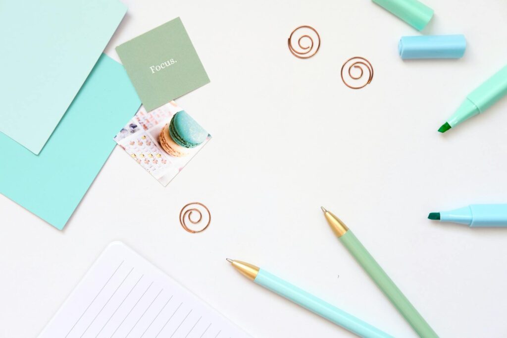 Navigating ADHD in Adults: Practical Strategies and Support Near Waterford, Michigan 7 Minimalist desk with teal stationery and focus note, ideal for productivity and mindfulness.