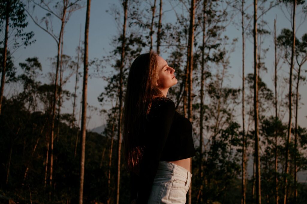 How Can I Manage Mental Health-Related Decision Fatigue and Improve Daily Functioning? 7 Portrait of a woman enjoying nature and freedom in a forest setting.